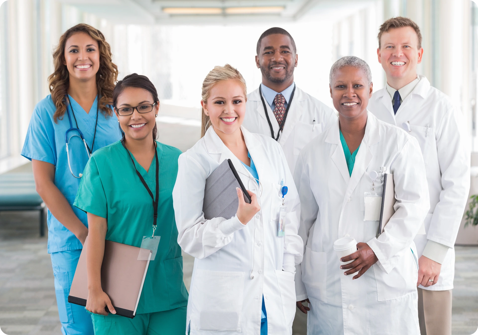 A diverse group of medical professionals smiling together.