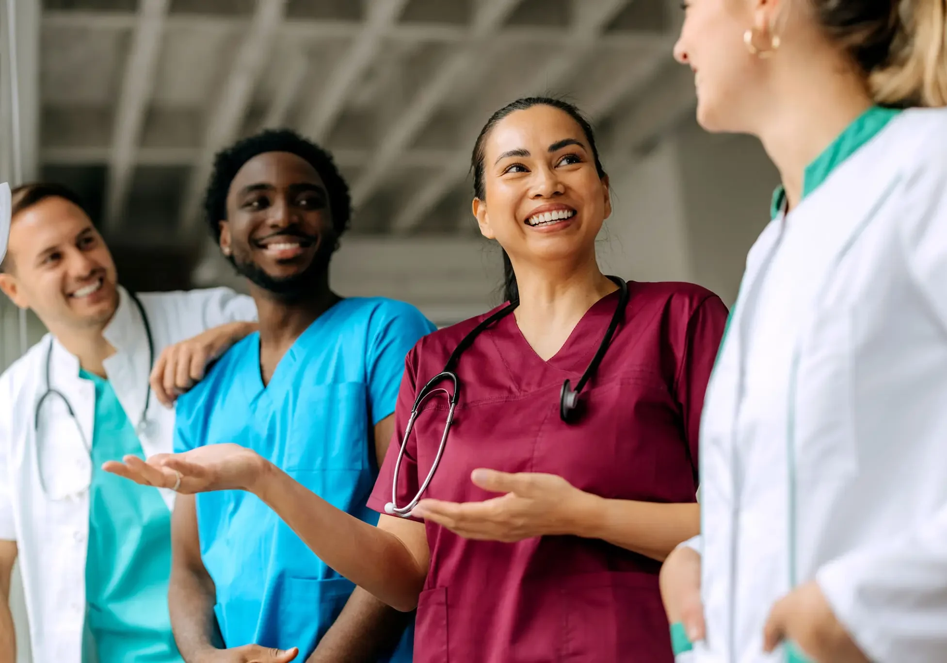 Medical professionals happily discussing in a hospital setting.